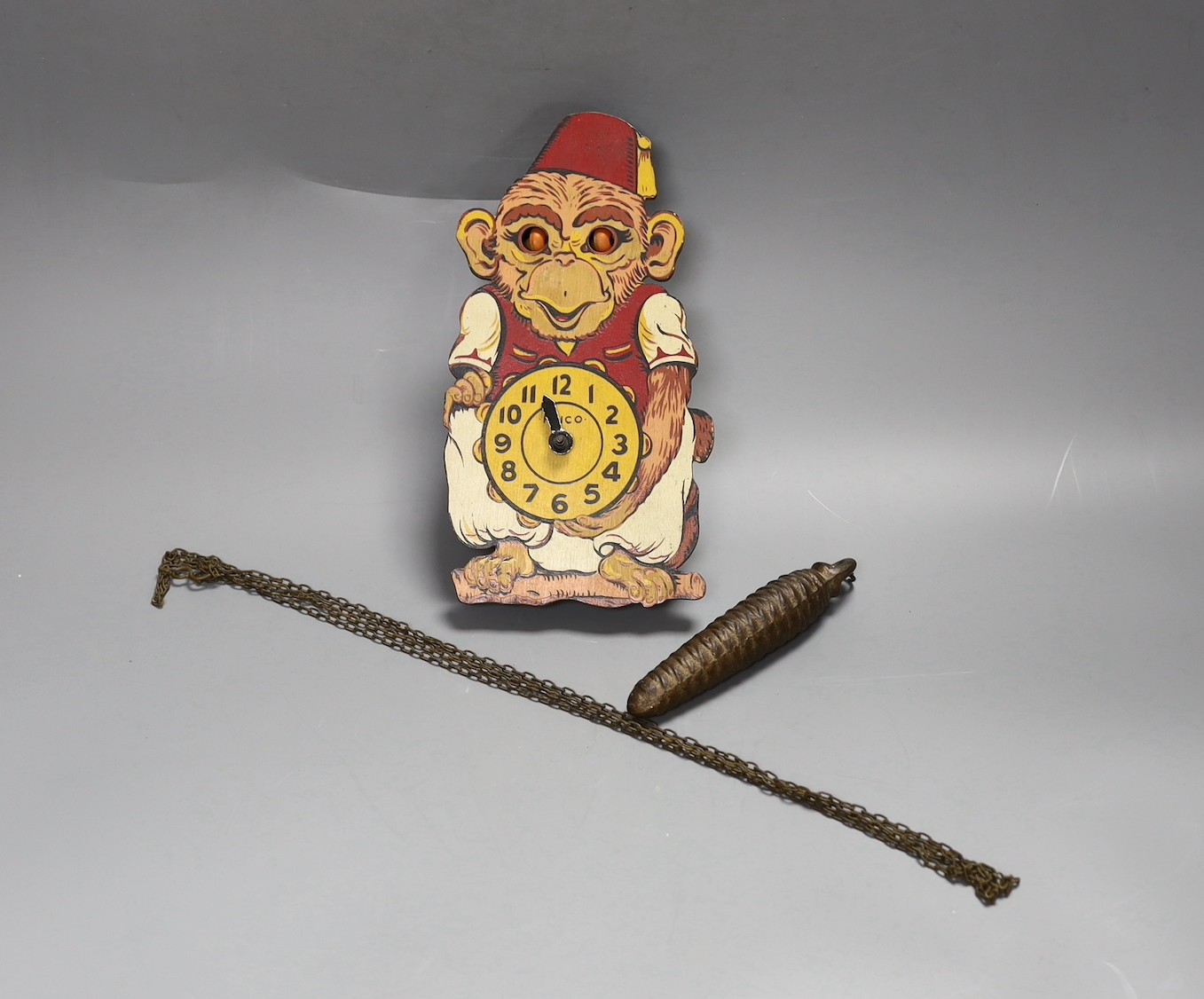 A Paico Wood and tin plate novelty monkey wall timepiece, 21cm